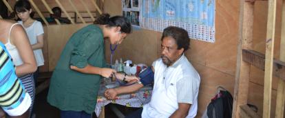 A volunteer doing a routine checkup on a man at her placement in Ghana A Projects Abroad volunteer doing a basic checkup on man at her Spring Break Public Health placement in Ghana